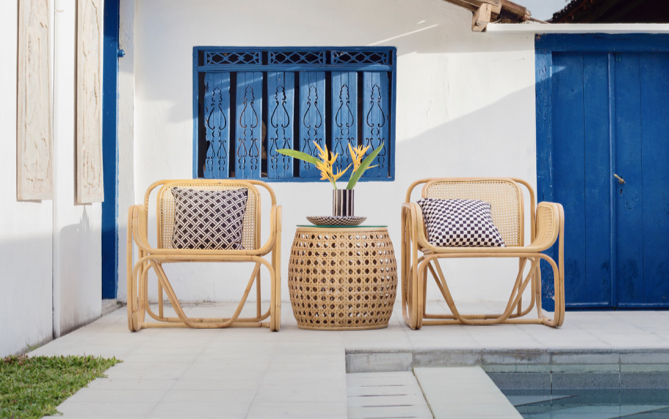 wicker patio set in front of a pool